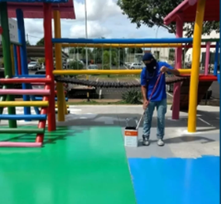 Profissional realizando trabalho de pintura em área externa